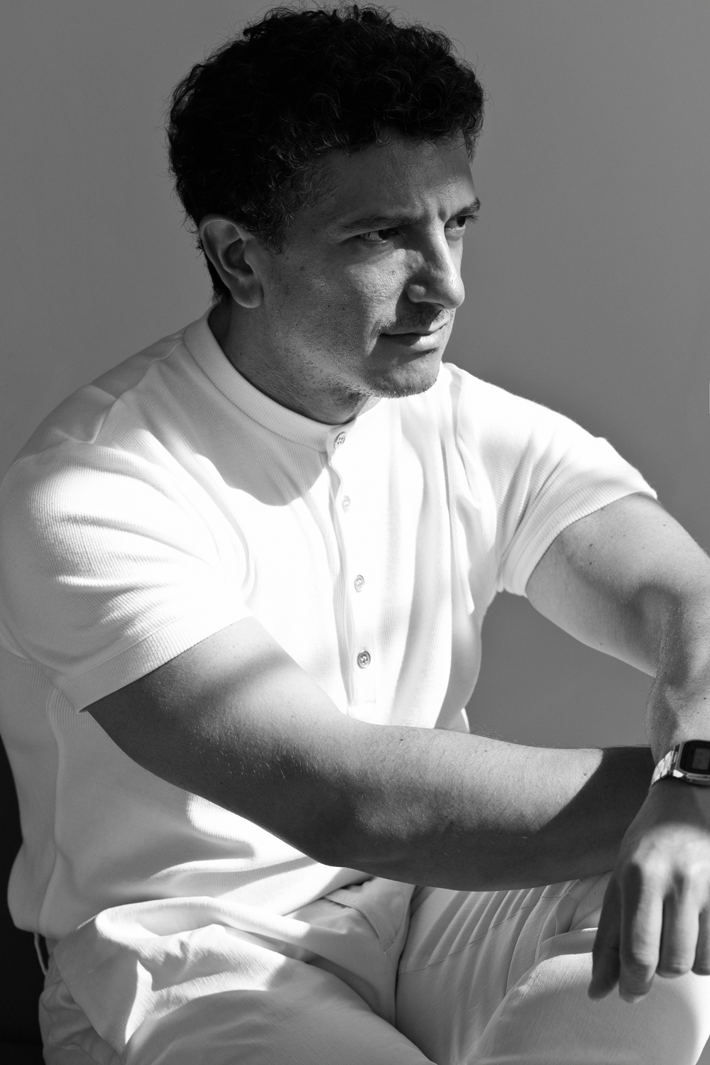 Matteo Russo seated in a thoughtful editorial portrait