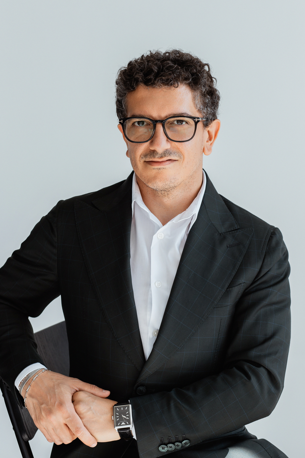 Matteo Russo seated in a black suit